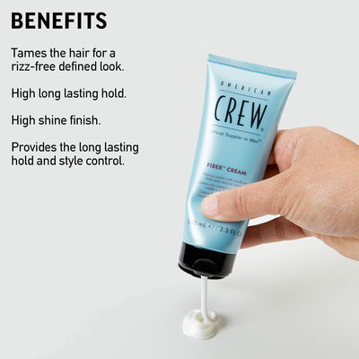 American Crew fiber cream tube held by a hand with product application on a white background